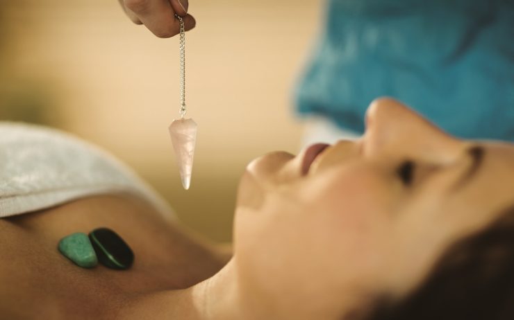 Young woman at crystal healing session in therapy room